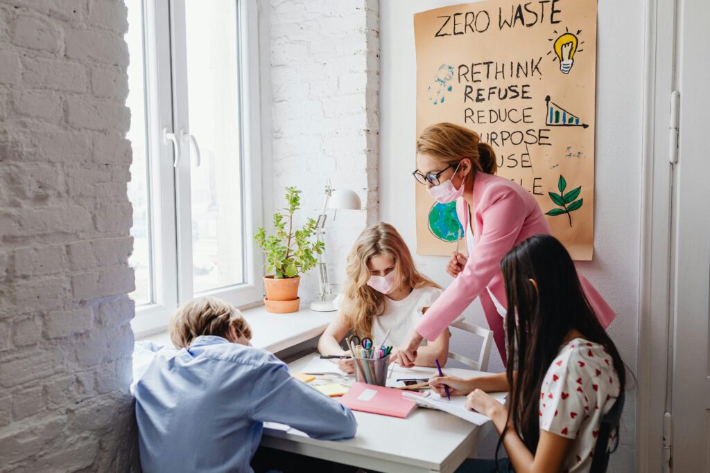 pexels-photo-7692644-7692644 A teacher guides students in a classroom project focused on zero waste education, promoting sustainability.