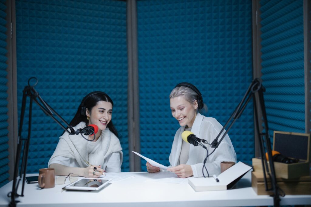 pexels-photo-7598562-7598562 Two women recording a podcast in a soundproof studio with professional equipment.